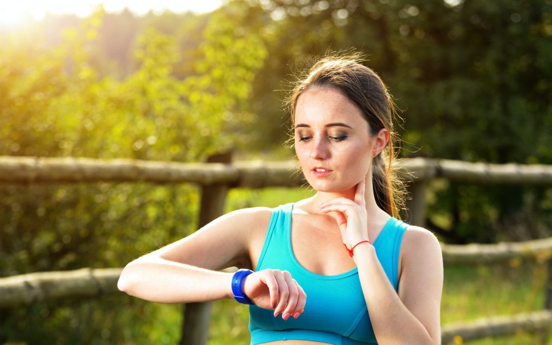 Woman using fitness bracelet
